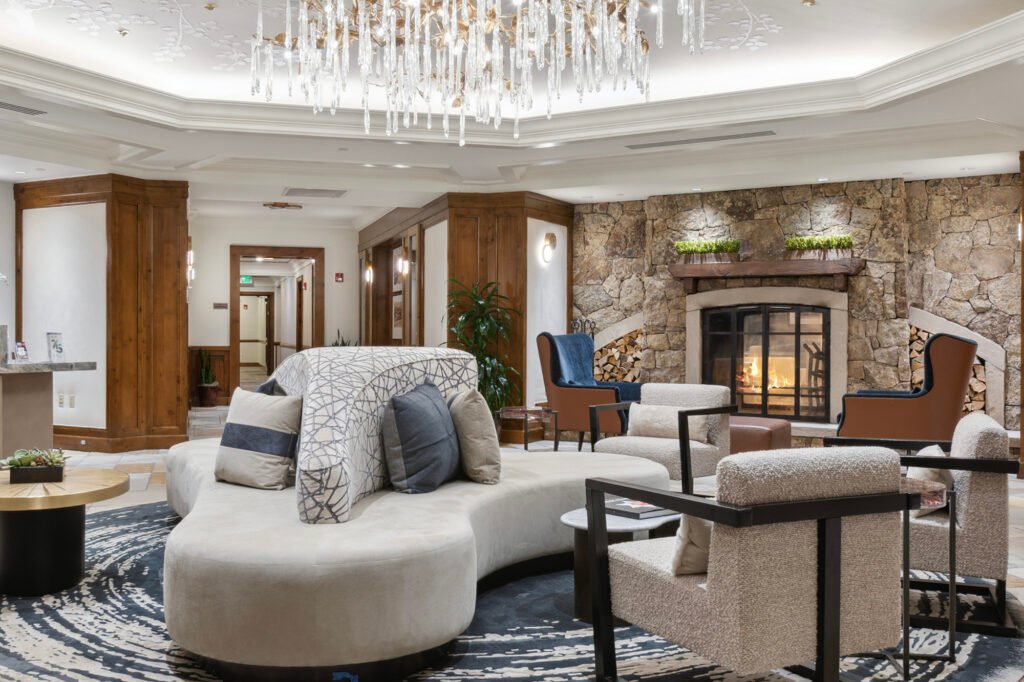Finished Aspen Mountain Residences lobby seating beside the stone fireplace.