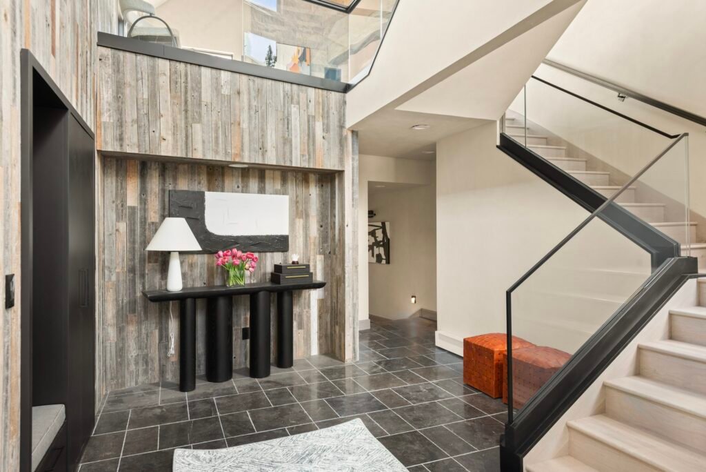 Portfolio 2 Faraway residence entry with wood wall finishes and glass stair railing in Snowmass