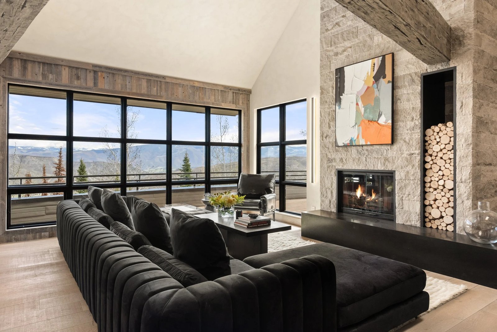 Custom Home Construction Consulting 1 Faraway residence great room with a stone fireplace and mountain views in Snowmass