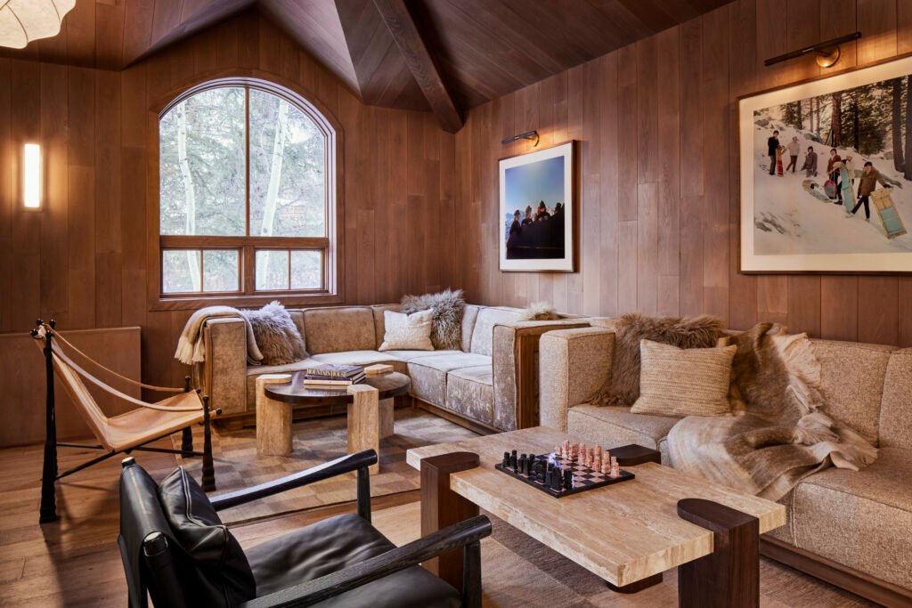 Completed Four Seasons Vail Chalet lounge with custom wood walls and seating