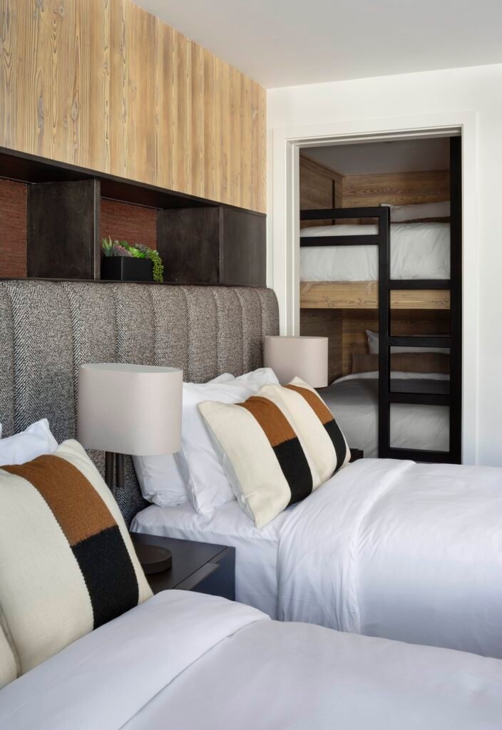 Renovated Paris penthouse bedroom and bunkroom with custom wood paneling