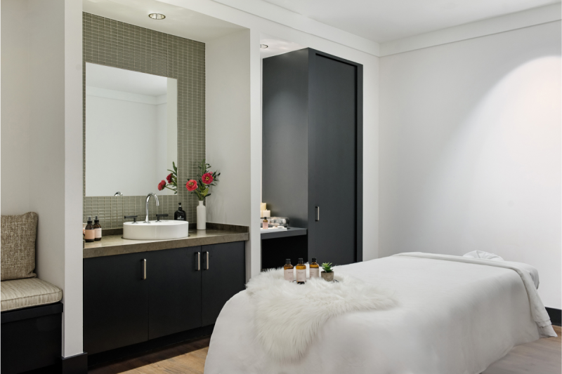 Renovated Four Seasons Vail spa treatment room with massage table and fitted cabinetry