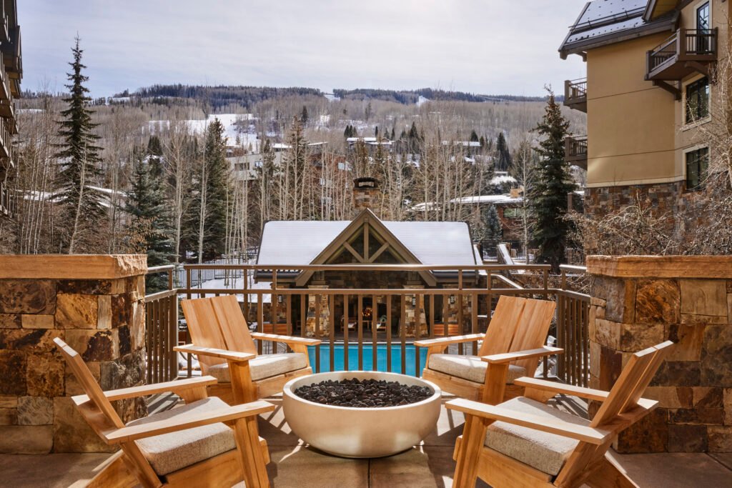 Tavernetta Vail terrace seating around a fire table with mountain views