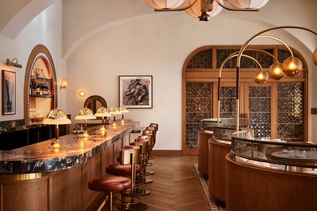 Tavernetta Vail 1 Completed Tavernetta Vail bar and dining room with custom lighting, stone bar top, and curved banquettes